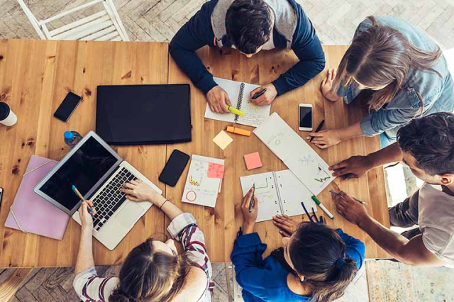 Image of adults around a table.