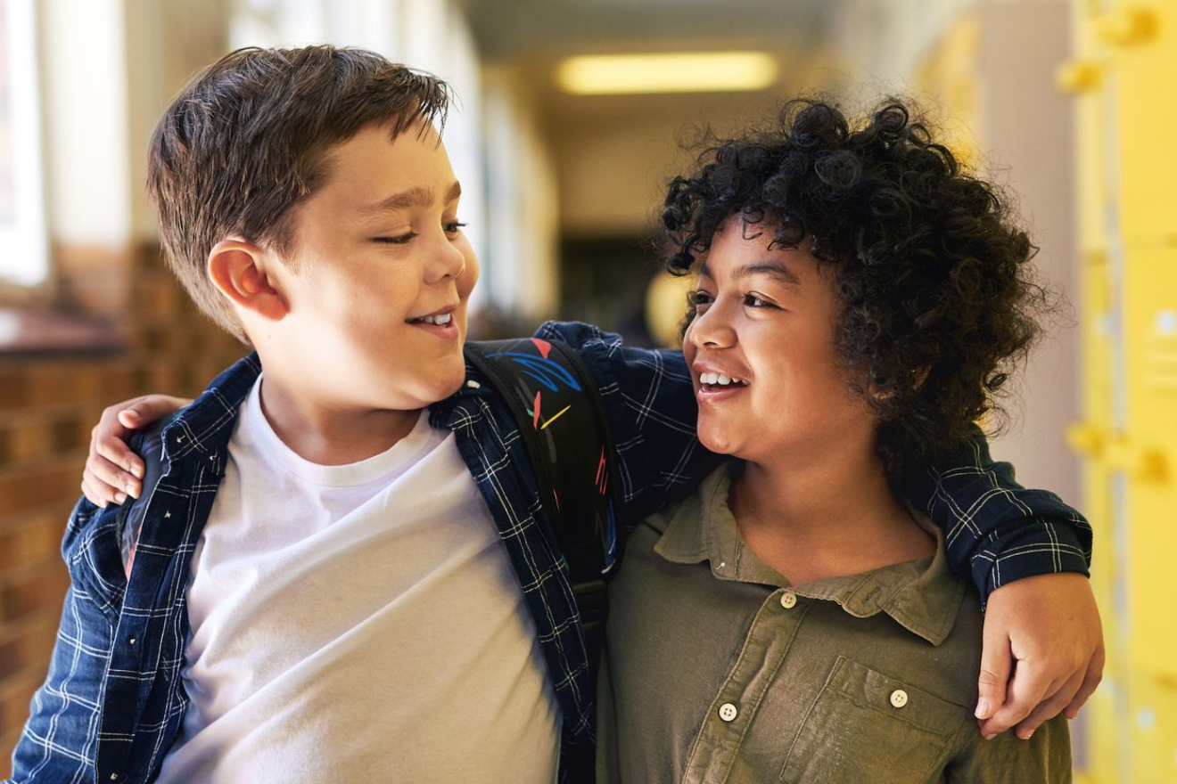 two kids with their arms around each other's shoulders