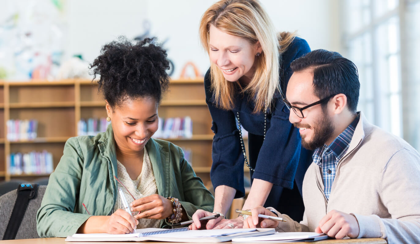 Adults reviewing programs together.