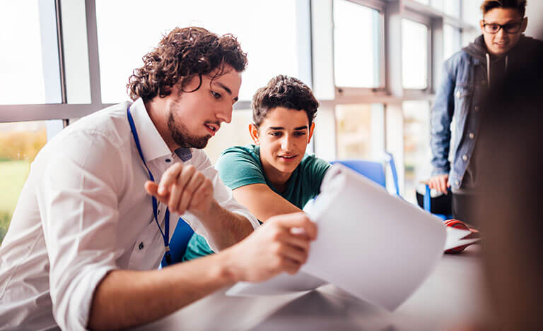 teacher showing student a document