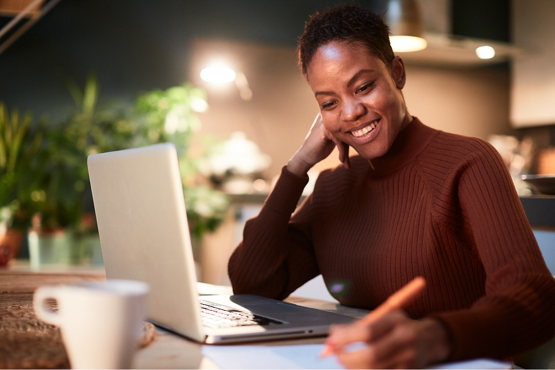 Support Your Goals A teacher at their desk with a laptop.